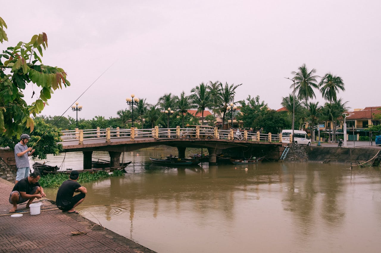 Visit Da Nang Hoi An local expert team member reviewing travel maps and planning authentic Vietnam itineraries at our Da Nang office