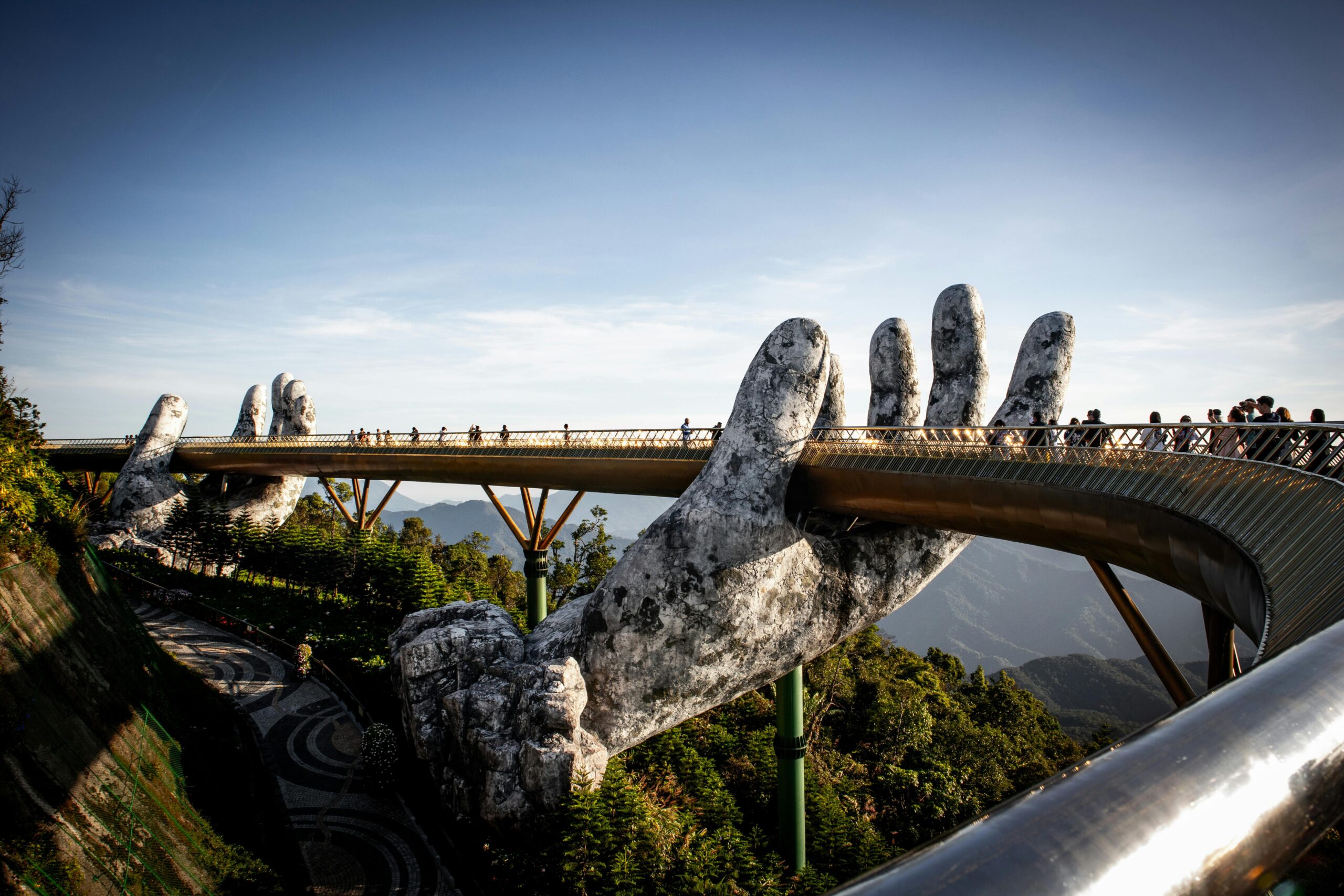 Ba Na Hills Golden Bridge held by giant stone hands with French village and cable car views